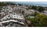 This aerial view taken on July 2, 2026, in Caraballeda in the state of La Guaira shows collapsed buildings following the June 24 twin earthquakes. (Photo by Miguel Medina / Pool / AFP)