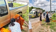This handout photo taken and released on July 2, 2026, by Parichat Kochakueng shows friend and nurse Wiwat Laonoi assisting injured Buddhist monks. Photo by Parichat Kochakueng / AFP