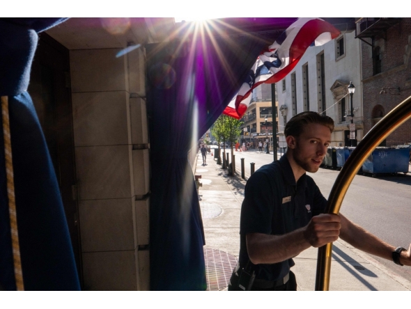 People walk through downtown Philadelphia after news that the Semiquincentennial Independence Day Parade has been canceled due to extreme heat in Philadelphia, Pennsylvania. (Photo by SPENCER PLATT / AFP)