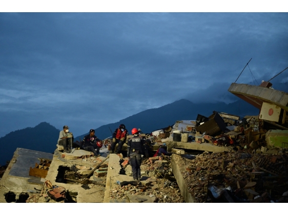Rescuers work on the rubble of a collapsed building in Caraballeda, La Guaira state, Venezuela, on July 3, 2026.  (Photo by MARTIN BERNETTI / AFP)
 