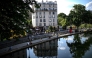 Files: People sit along the canal Saint-Martin in Paris on May 17, 2022. Photo by Christophe Archambault / AFP