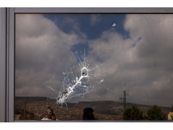 This picture shows a bullet hole on the window of a restaurant after it was burned down by settlers during an attack in the western area of the Al-Lubban ash-Sharqiya village, south of Nablus, in the occupied West Bank on on July 5, 2026. (Photo by JAAFAR ASHTIYEH / AFP)