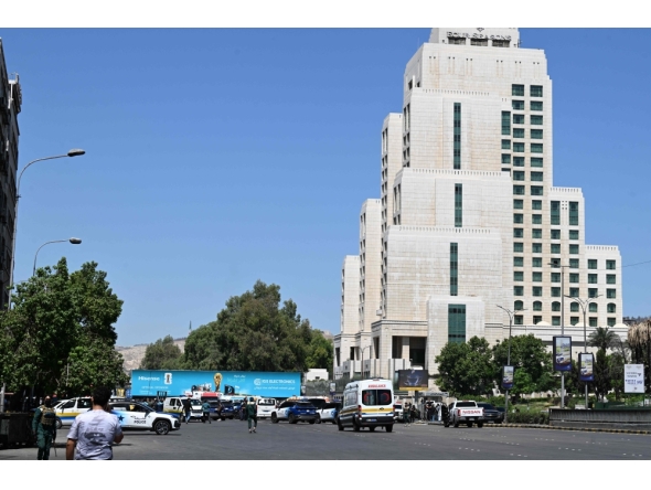 Syrian police officers and emergency personnel gather near the Four Seasons Hotel following two explosions nearby in Damascus on July 7, 2026. (Photo by AFP)