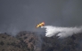 A picture taken on July 10, 2026 shows a Canadair water bombing aircraft on the site of a wildfire that killed 11 near Los Gallardos, in Almeria Province. (Photo by Jose Jordan / AFP)
