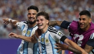 Argentina's forward #09 Julian Alvarez (C) celebrates scoring his team's second goal with Argentina's forward #21 Jose Manuel Lopez (L) and Argentina's defender #13 Cristian Romero. Photo by Odd Andersen / AFP