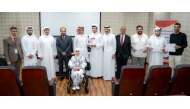 Director of Human Resources at QIIB Sheikh Ali bin Abdullah al-Thani and Executive Director of the Qatar Society for Rehabilitation of Special Needs Amir al-Mulla alongside senior representatives from both organisations pose for a group photo.
