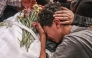 A relative mourns over the body of 17-year-old Fadi al-Naasan during his funeral in the village of Al-Mughayyir, east of Ramallah in the Israeli-occupied West Bank, on July 18, 2026. (Photo by JAAFAR ASHTIYEH / AFP)