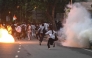 Rapid Action Force (RAF) personnel fire tear gas shells to disperse supporters of the Cockroach Janta Party (CJP) during a protest demanding the resignation of India's Education Minister Dharmendra Pradhan over alleged NEET exam irregularities in New Delhi on July 20, 2026. (Photo by Arun SANKAR / AFP)