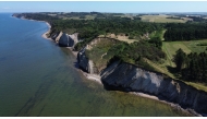 This aerial view shows the Hanklit cliff overlooking Limfjord on the Danish island of Mors, Denmark on July 9, 2026. (Photo by James Brooks / AFP)