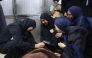 Mourners weep over the body of one of the Palestinian who died after an Israeli airstrike targeted a residential apartment in the Sabra neighborhood of Gaza City on July 21, 2026. (Photo by Omar AL-QATTAA / AFP)
