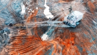 A large walking excavator works in a quarry for the extraction of rare metals. 
