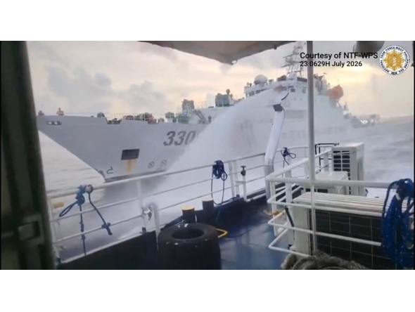 This handout screengrab taken on July 23, 2026 and released by the Philippine Coast Guard (PCG) shows a Chinese Coast Guard ship (back) water canonning a Philippines' Bureau of Fisheries and Acquatic Resources (BFAR) ship near Scarborough Shoal, in the disputed South China Sea. (Photo by Handout / Philippine Coast Guard (PCG) / AFP) /