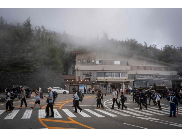 Climbers arrive at the fifth station of Mount Fuji in Fujiyoshida, Yamanashi prefecture on July 23, 2026. (Photo by Yuichi Yamazaki / AFP)