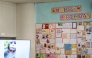 A TV screen showing the footages of the male Japanese macaque monkey named 'Punch' is pictured next to a wall with birthday messages for its upcoming one-year-old birthday, at Ichikawa City Zoo and Botanical Gardens in Ichikawa on July 24, 2026. (Photo by Philip Fong / AFP)