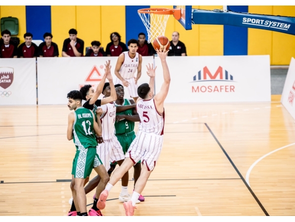 Qatar's Tameem Ashraf Abuissa (right) prepares to shoot.