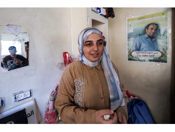 Palestinian high-school student Saba Rabah, the top-ranked student in the science stream of the Palestinian national high school exams, reacts at the Maghazi camp on July 26, 2026. (Photo by Eyad Baba / AFP)