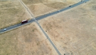 This aerial image shows a red London bus driving past the scorched grass on Blackheath in south east London, on July 29, 2026. (Photo by Justin Tallis / AFP)