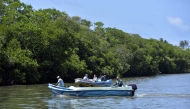 People boat near the mangroves in the Negombo Lagoon in Negombo, Sri Lanka. (Photo by Gayan Sameera/Xinhua)