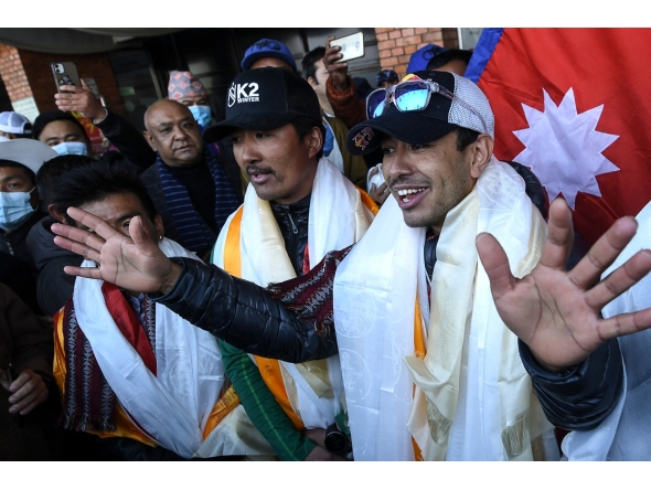 Nepali mountaineer Nirmal Purja (R) talks to the media along with his team at the Tribhuvan International airport after becoming the first to summit Pakistan's K2 mountain in winter, in Kathmandu on January 26, 2021. Photo by PRAKASH MATHEMA / AFP