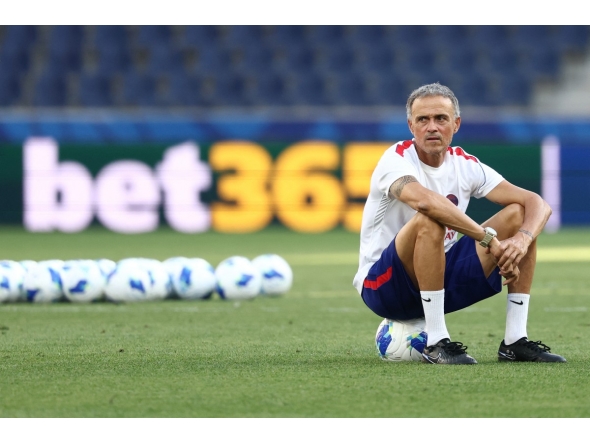 Paris Saint-Germain's Spanish coach Luis Enrique sits on a ball as he oversees a training session of his players on August 11, 2026, the eve of the UEFA Supercup football match between Champions League winners Paris Saint Germain (PSG) and Europa League winners Aston Villa in Salzburg, Austria. (Photo by FRANCK FIFE / AFP)