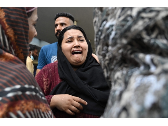 A mother reacts after the death of her child following a fire incident outside the Mother and Child Health (MCH) ward at the Pakistan Institute of Medical Sciences (PIMS) Hospital in Islamabad on August 26, 2026. (Photo by Aamir QURESHI / AFP)