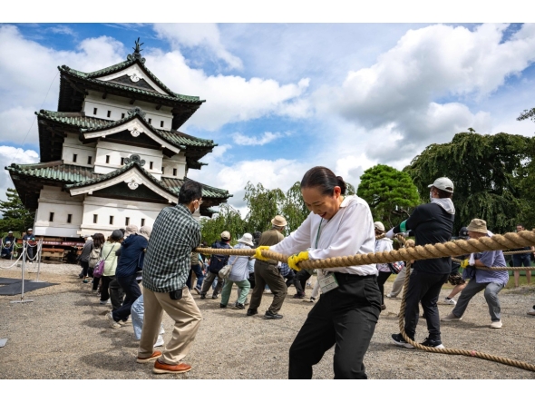 Participants pull Hirosaki Castle using ropes to its original position following repair works in Hirosaki, Aomori Prefecture on August 26, 2026. (Photo by Philip FONG / AFP)