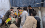 This photograph taken and released by the Khyber Pakhtunkhwa province's Emergency Service (Rescue 1122) on October 15, 2026 shows rescue workers during a search operation after a roof collapsed at a school in Peshawar. (Photo by Handout / Khyber Pakhtunkhwa province's Emergency Service (Rescue 1122) / AFP)
