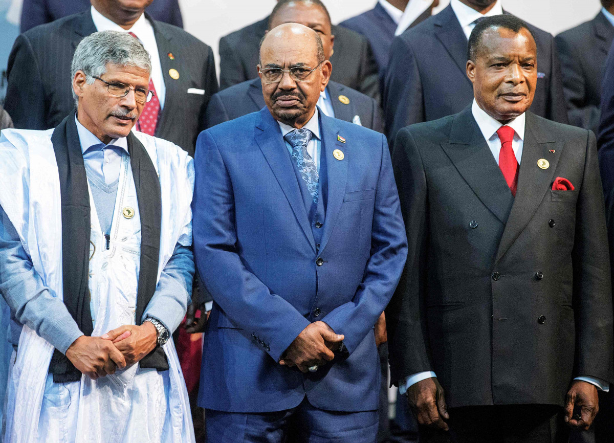 This file photo taken on June 14, 2015 shows Sudanese President Omar al-Bashir (C) standing next to Congo's president Denis Sasso-Nguesso (R) and Prime Minister of the Sahrawi Arab Democratic Republic Abdelkader Taleb Oumar (L) posing during a photo call