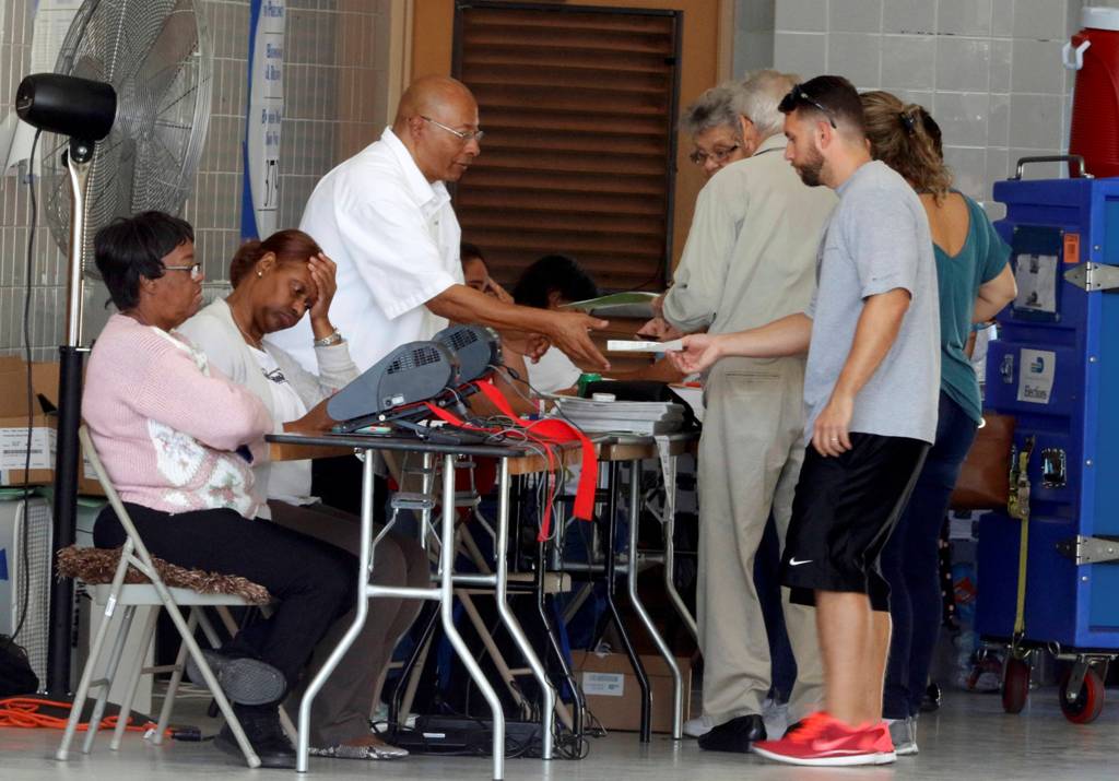 A voter shows his identification during the U.S. presidential election in Hialeah, Florida, U.S. November 8, 2016. REUTERS/Joe Skipper
