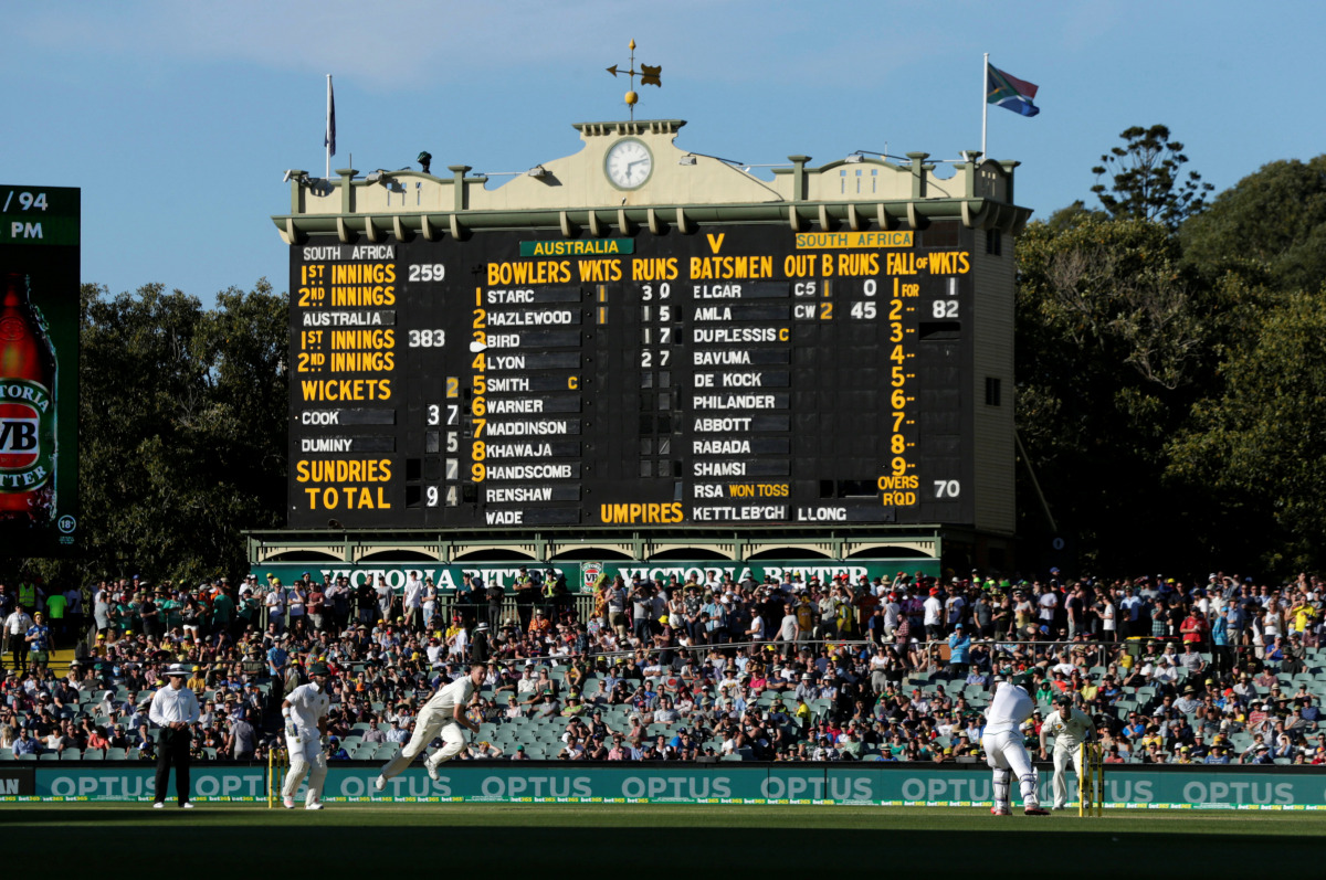 Australian bowler Jackson Bird delivers to South Africa's Stephen Cook in front of the old scoreboard during the third day of the Third Test cricket match in Adelaide. (Reuters/Jason Reed)