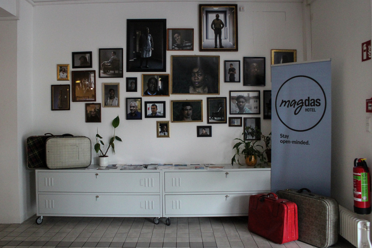 Entrance of the hotel shows pictures of staff who are refugees (Showkat Shafi / Al Jazeera) 