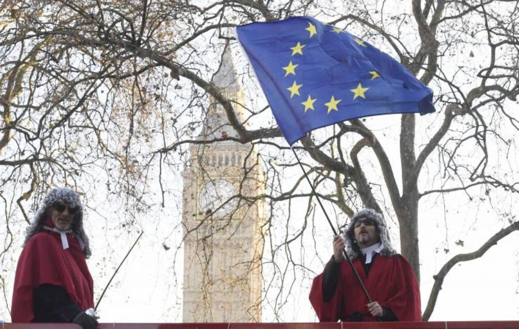 Protesters wearing judges' wigs and robes ride an open top bus past the Supreme Court ahead of the challenge against a court ruling that Theresa May's government requires parliamentary approval to start the process of leaving the European Union, in Parlia