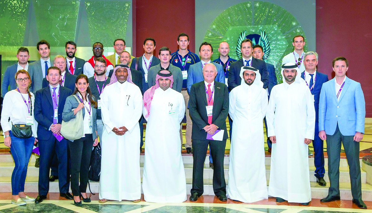 Mohammad Al Kuwari, Director of Venues and Events at Aspire Logistics, Ateeq Sultan, Director of Supply Chain, and Nasser Abdullah Al Hajri, Director of PR and Communications with other senior officials pose for a photograph with the delegates from intern