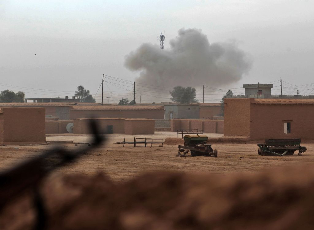 Smoke rises from the village of Shwah, south of the city of Tal Afar on the western outskirts of Mosul, on December 13, 2016, as Shiite fighters from the Hashed al-Shaabi (Popular Mobilisation) paramilitary units advance towards the village during an ongo