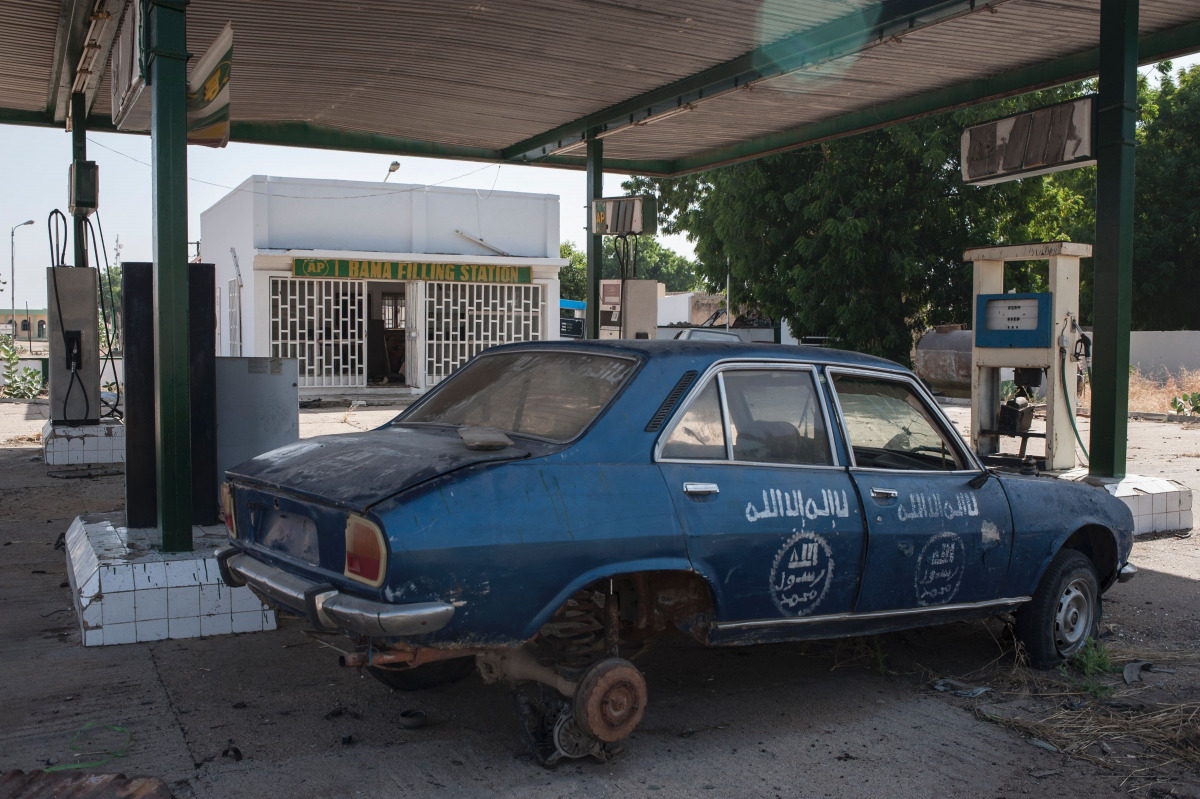 A picture taken on December 98, 2016 shows a gas filling station destroyed by Boko Haram in Bama, in northeast Nigeria. The houses are burnt-out shells, and charred cars and petrol pumps line the roads in the once-bustling Nigerian trade hub of Bama befor