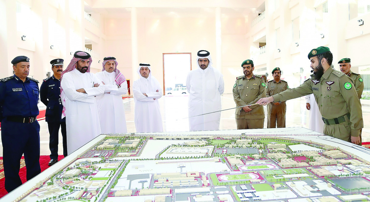 Deputy Emir H H Sheikh Abdullah bin Hamad Al Thani being briefed on the model of new buildings, at the Emiri Guard premises yesterday.