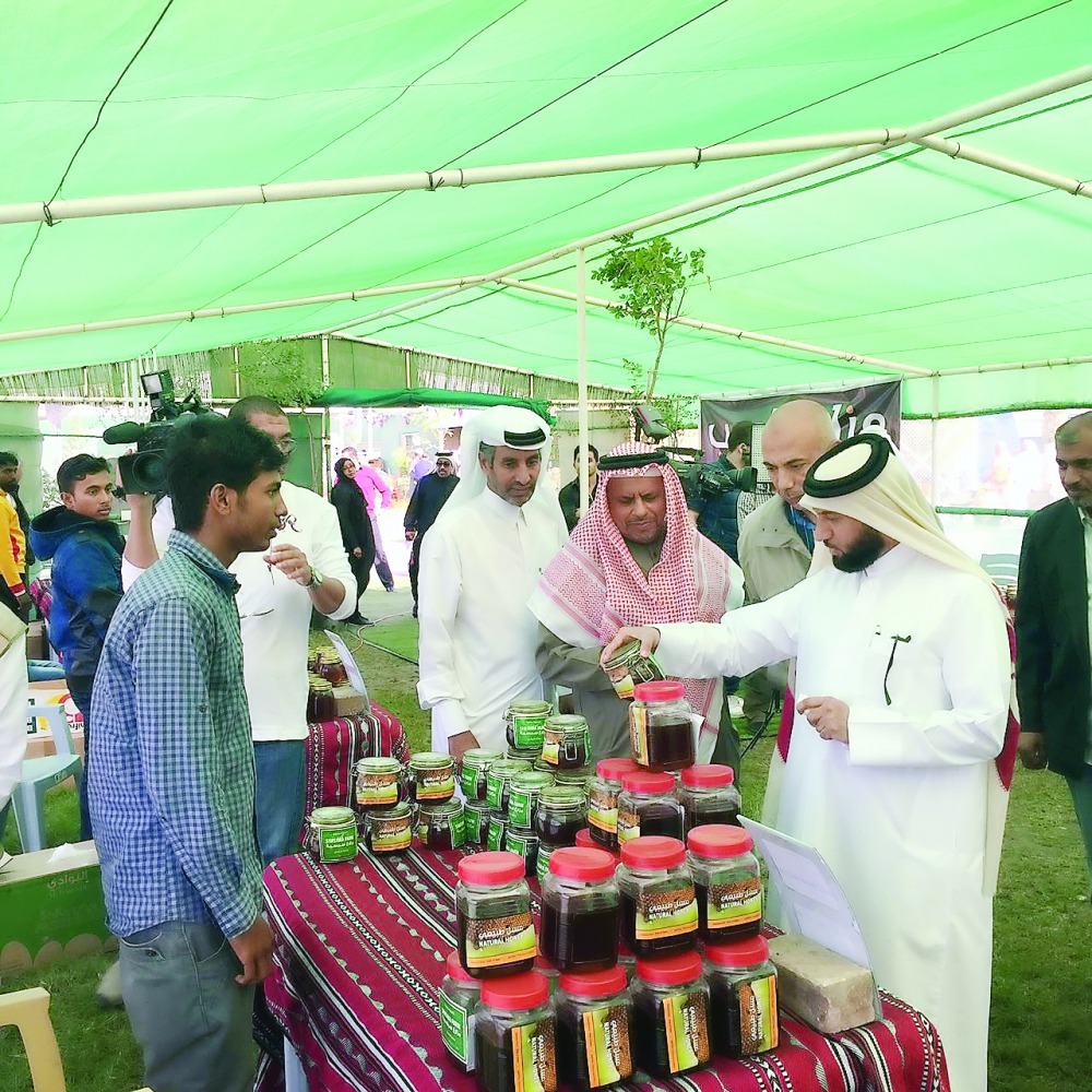 Yousuf Al Khulaifi, Director, Agricultural Affairs Department, visiting a honey stall at the winter vegetable market in Al Mazrouah Yard, in Umm Salal, yesterday.