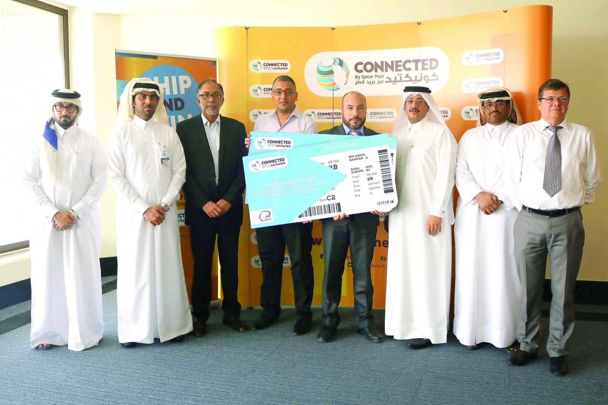 The winners of the ship & win draw from CONNECTED by Qatar Post with officials.