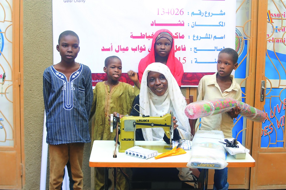 A beneficiary family with a sewing machine provided by Qatar Charity as part of its humanitarian projects in Chad.