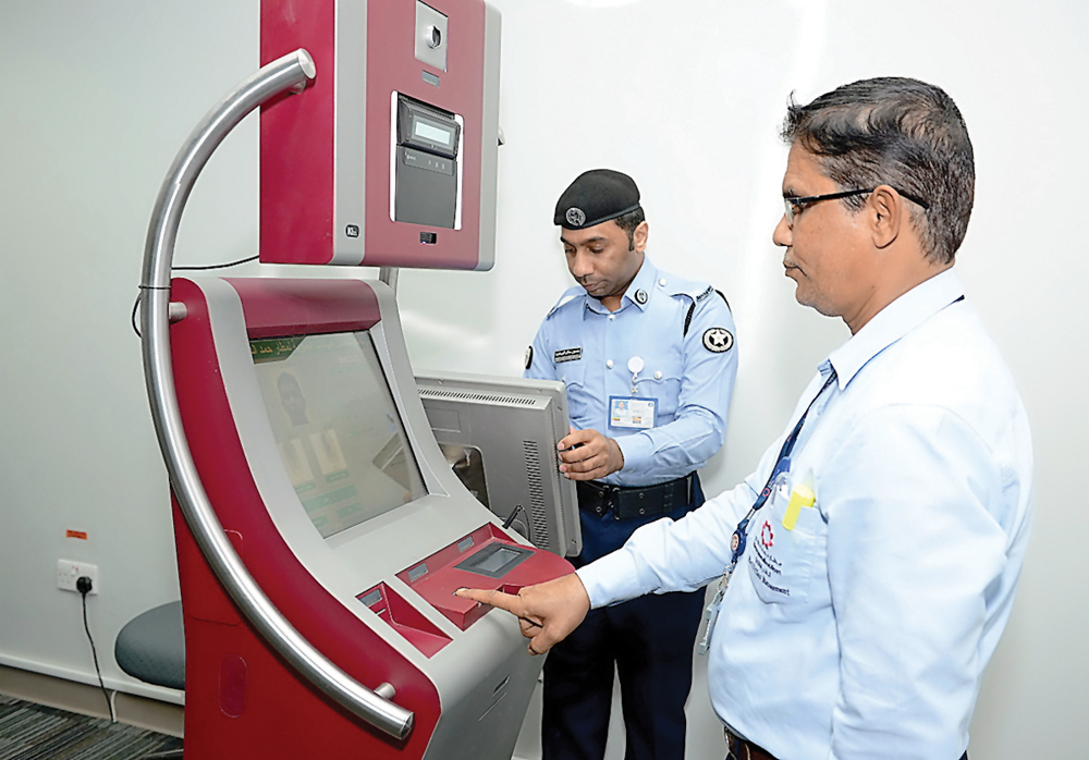 Officials displaying the use of a self-service machine at HIA.