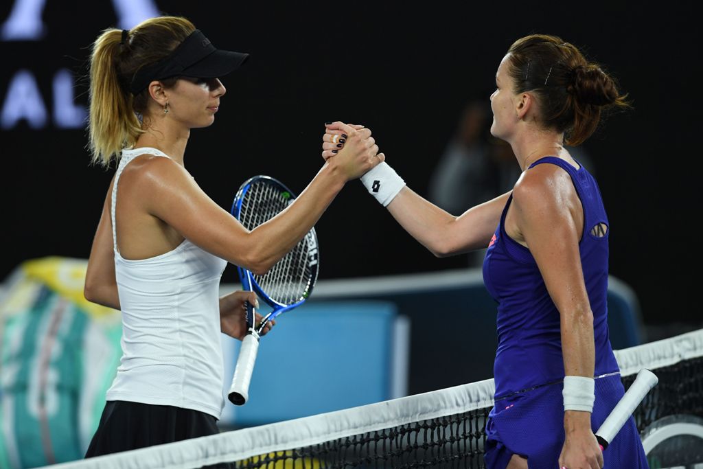 Poland's Agnieszka Radwanska (R) shakes hands with Bulgaria's Tsvetana Pironkova after victory during their women's singles match on day two of the Australian Open tennis tournament in Melbourne on January 17, 2017.   AFP / GREG WOOD