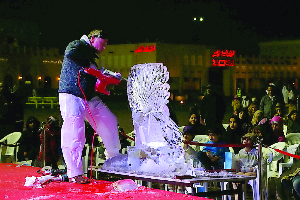 Visitors enjoy ice carving at the fourth Katara Winter Festival at Katara Cultural Village, yesterday.