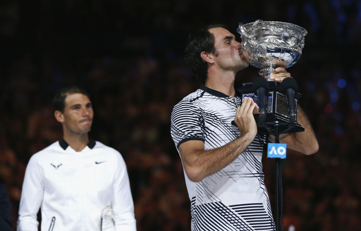Switzerland's Roger Federer kisses the trophy after winning his Men's singles final match against Spain's Rafael Nadal. (REUTERS/Issei Kato)