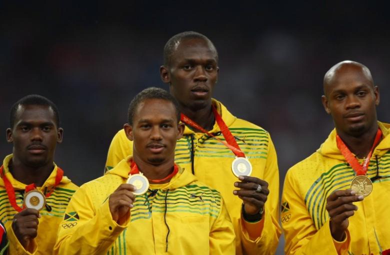 Gold medalists (L - R) Nesta Carter, Michael Frater, Usain Bolt, Asafa Powell of Jamaica pose during the medal ceremony for the men's 4 x 100m relay final of the athletics competition in the National Stadium at the Beijing 2008 Olympic Games August 23, 20