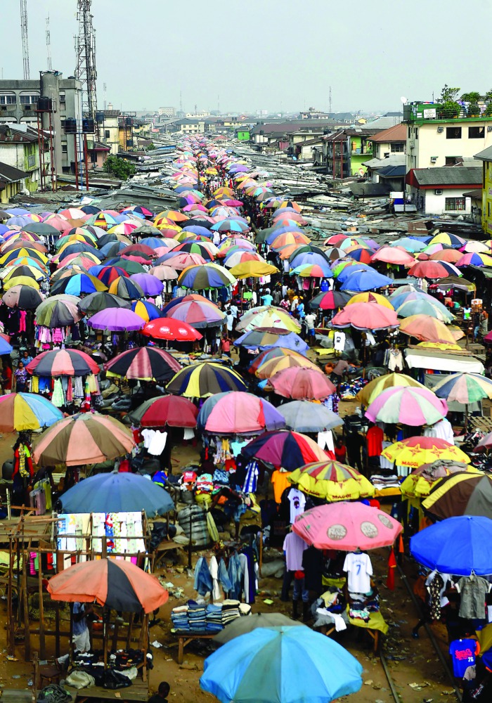 Traders cover their wares with umbrellas of different shapes and sizes along the railway line in Port Harcourt city, Rivers State, on February 14, 2017. The Nigerian city of Port Harcourt used to be known as 