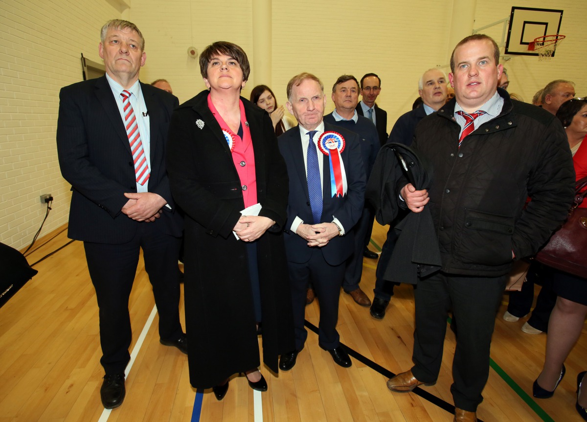 Arlene Foster (2L) stands with Party Chairman Maurice Morrow, Baron Morrow (3L), who lost his seat in the Northern Ireland Assembly elections, at the count centre in Omagh, Co Tyrone, Northern Ireland, on March 3, 2017. AFP / Paul Faith