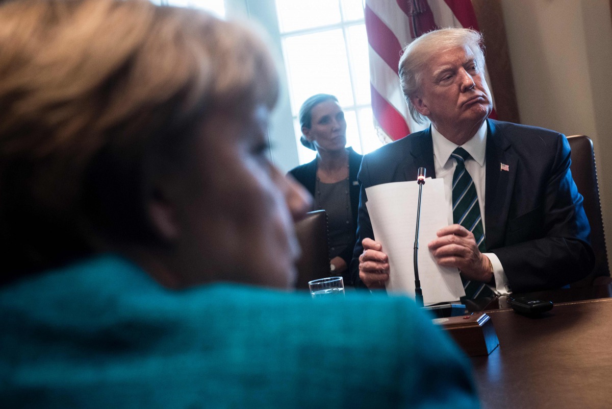 Germany's Chancellor Angela Merkel (L) and US President Donald Trump listen as participants introduce themselves before a meeting with Germans and US business leaders in the Cabinet Room of the White House March 17, 2017 in Washington, DC. AFP / Brendan S