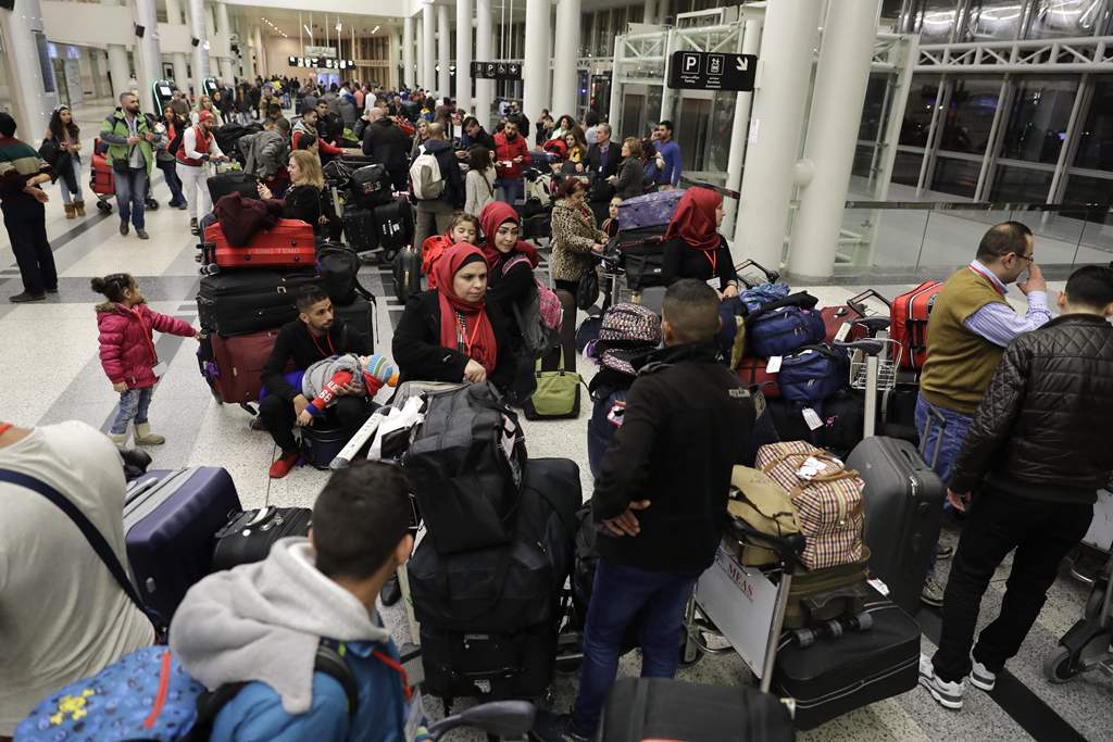 Syrian refugees, who were granted humanitarian visas by the Italian government gather at the departures hall in Beirut's International airport on March 1, 2017 ahead of their flight to Rome. AFP / JOSEPH EID