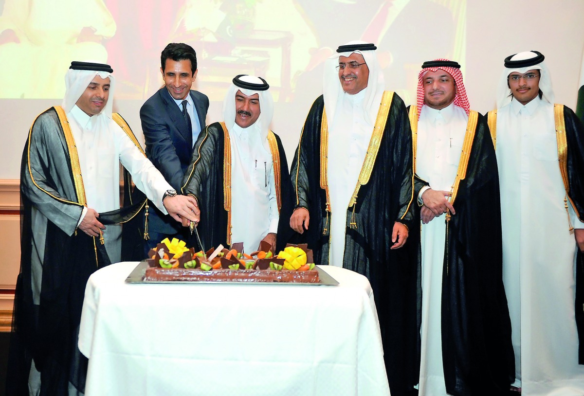 H E Dr Mohammed Abdul Wahed Ali Al Hammadi (left), Minister of Education and Higher Education, and Secretary-General of Qatar's Foreign Ministry, Dr Ahmad bin Hassan Al Hamadi (third left), cutting the cake with Shahzad Ahmad, Ambassador of Pakistan, at a