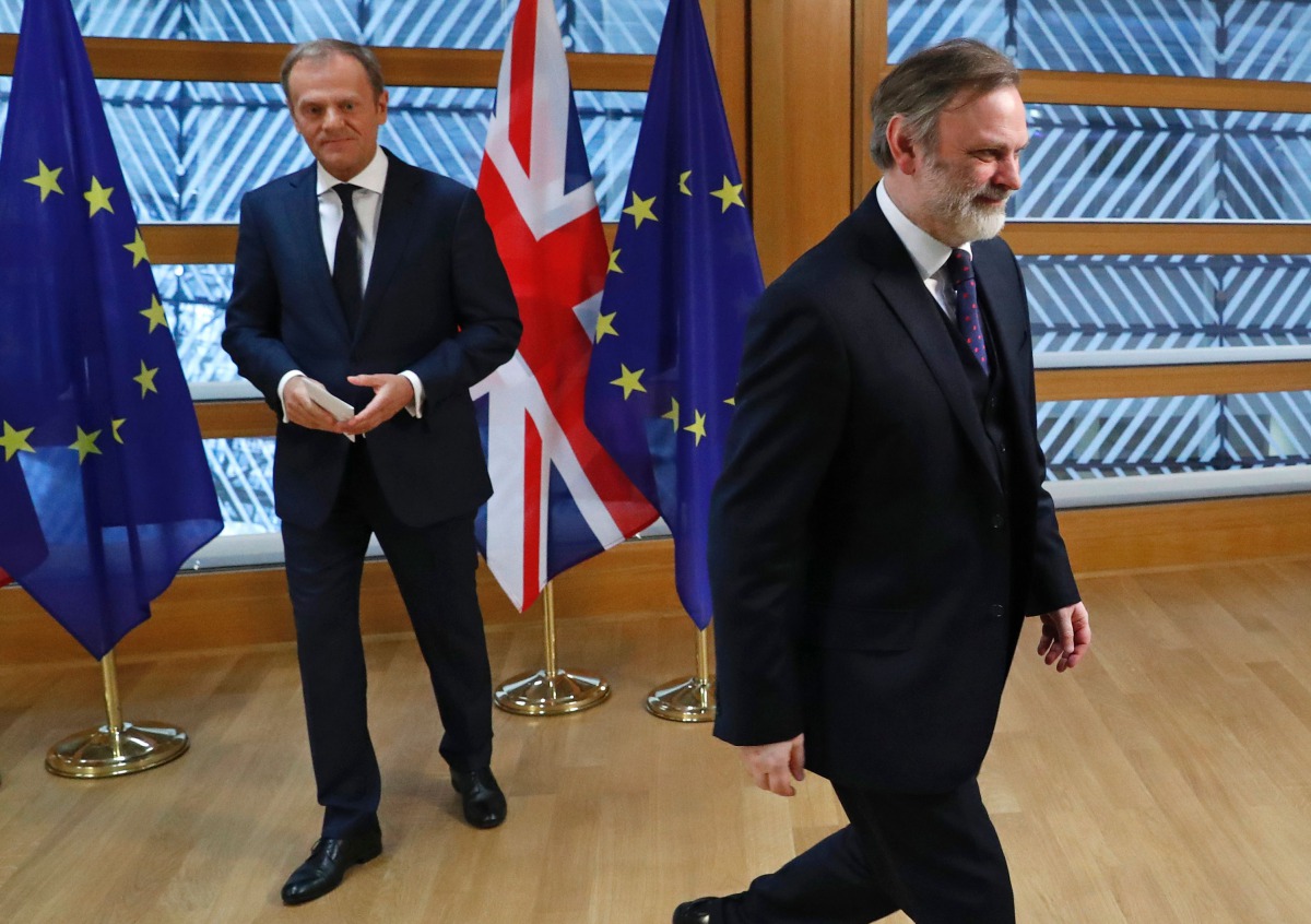 Britain's Ambassador to the EU Tim Barrow (R) walks away after handing European Council President Donald Tusk the British prime minister's formal notice of the UK's intention to leave the EU under Article 50 of the Lisbon Treaty in Brussels on March 29, 2
